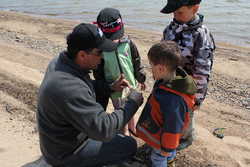 Showing kids the teeth on a pike skull 